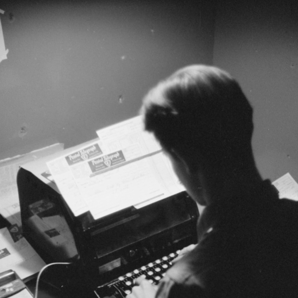 A person typing at a typewriter